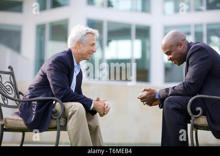 Two businessmen having a discussion outside. Stock Photo