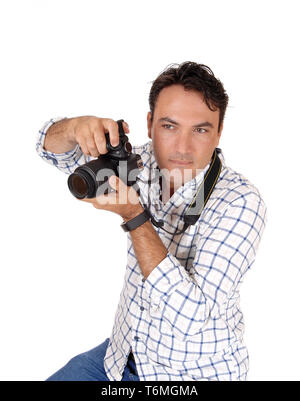 A young man holding his camera ready for a shoot Stock Photo