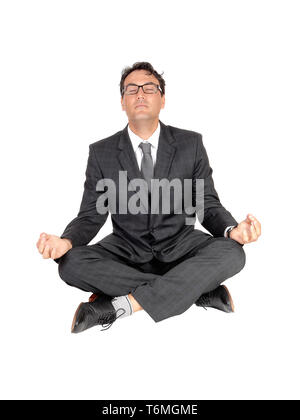 Business man sitting on floor doing yoga Stock Photo