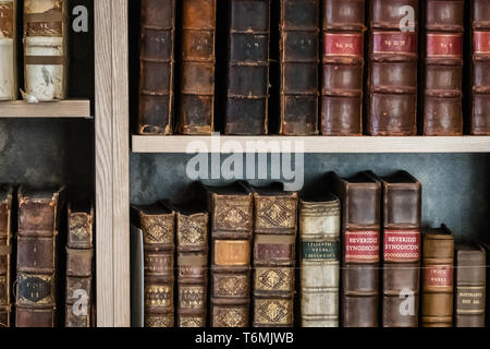 Antique books on shelf in a library Stock Photo