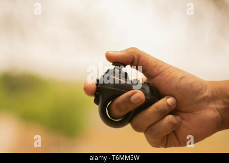 Closeup of hand using Virtual Reality gaming bluetooth controller of mobile. Stock Photo