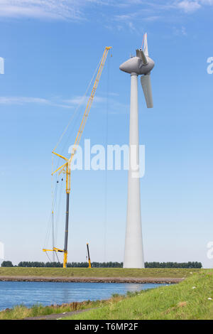 Construction site Dutch windturbine with large crane Stock Photo