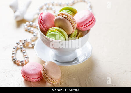 Colourful macaroons on the plates Stock Photo