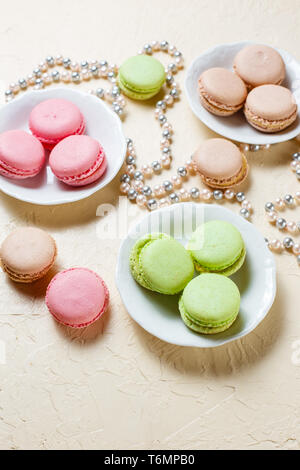 Colourful macaroons on the plates Stock Photo