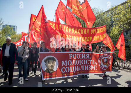 Moscow, RUSSIA - MAY 1, 2019: Moscow's Labor Day Parade. A poster with a portrait of Lenin: Russia, youth, socialism Stock Photo