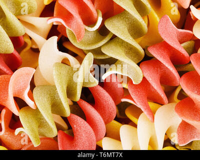 Multicolored Raw Spiral Pasta Stock Photo