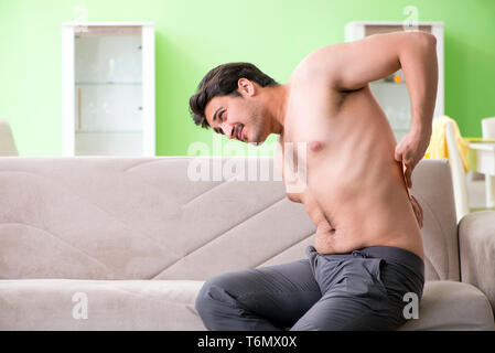 Man applying pepper Capsicum plaster to relieve pain Stock Photo