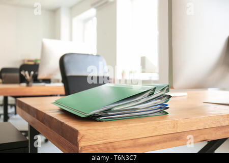 Workplace with computer and folders on table in modern office Stock Photo