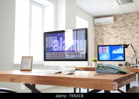 Workplace with computer and folders on table in modern office Stock Photo