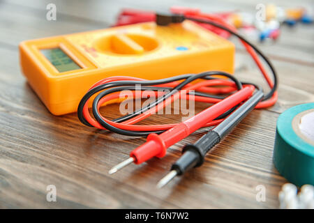 Multimeter on wooden table. Electrical tools Stock Photo