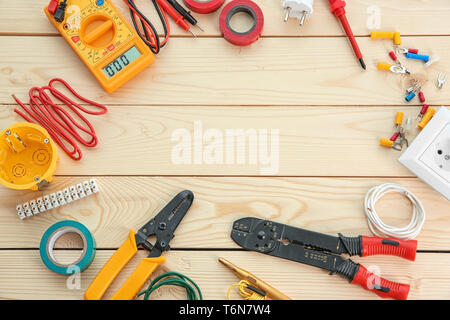 Flat lay composition with electrical tools on wooden background Stock Photo