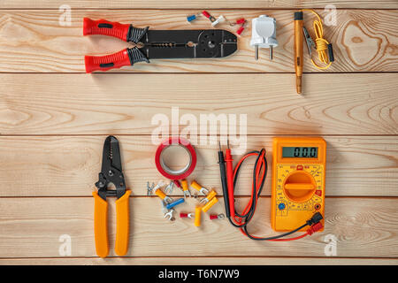 Flat lay composition with electrical tools on wooden background Stock Photo