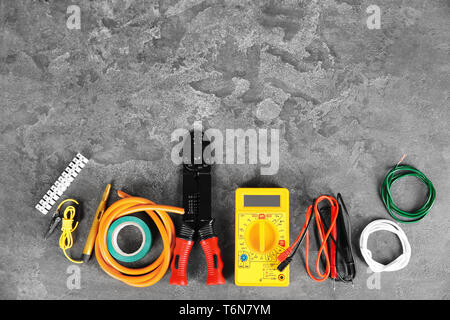 Flat lay composition with electrical tools on grey background Stock Photo