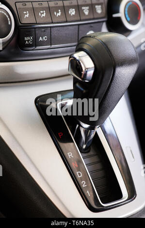 Automatic car gearbox stick on dashboard panel background Stock Photo