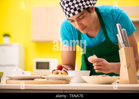 The man cook preparing cake in kitchen at home Stock Photo