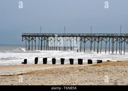 Pier on a Beach with Breaking Waves Stock Photo