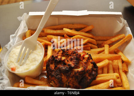 Eating a Crab Cake & French Fries Stock Photo