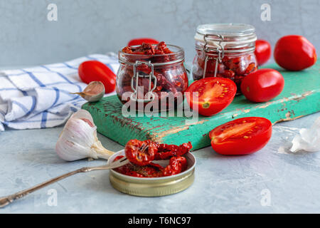 Homemade dried tomatoes in glass jars. Stock Photo