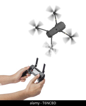Drone and radio remote control in hands Stock Photo