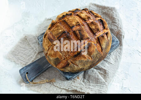 Loaf of bread on sourdough from wheat and rye flour. Stock Photo