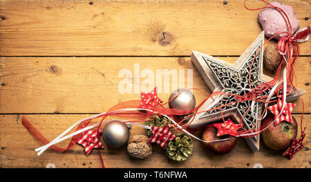 Christmas decoration red ribbon on a star with wooden background