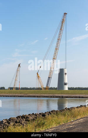 Big crane busy with construction of a new Dutch windturbine Stock Photo