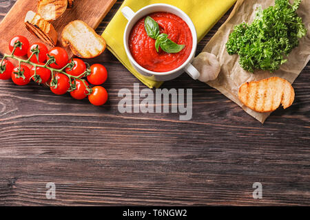 Composition with tasty tomato sauce on wooden background Stock Photo