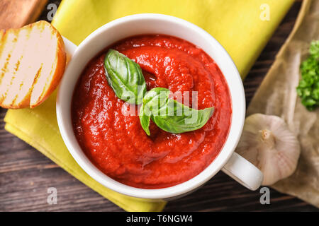 Tureen with tasty tomato sauce on table, top view Stock Photo