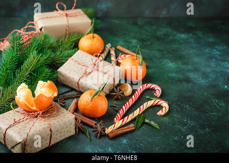 Cinnamon, candy canes and tangerines with leaves Stock Photo