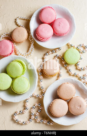Colourful macaroons on the plates Stock Photo