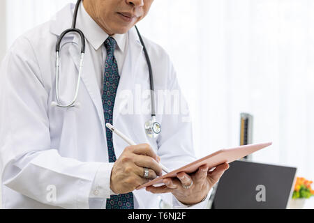 senior Doctor using tablet Stock Photo
