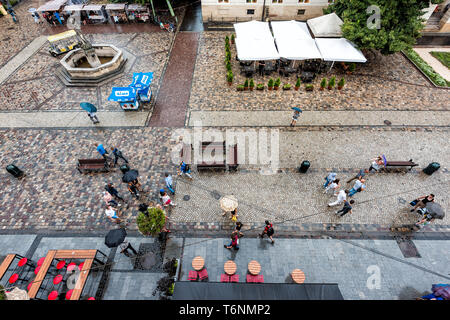 Lviv, Ukraine - July 31, 2018: Aerial high angle view looking down of historic Ukrainian city in old town market square with cafe restaurant water fou Stock Photo