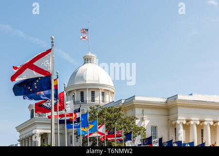 Montgomery, USA State capitol building in Alabama during sunny day with old historic architecture of government and many row of flags by dome Stock Photo