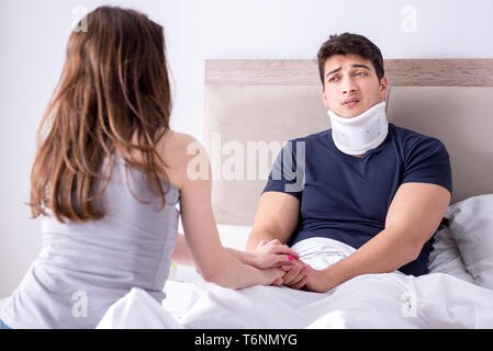 The loving wife taking care of injured husband in bed Stock Photo