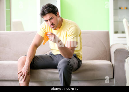 The man applying pepper capsicum plaster to relieve pain Stock Photo