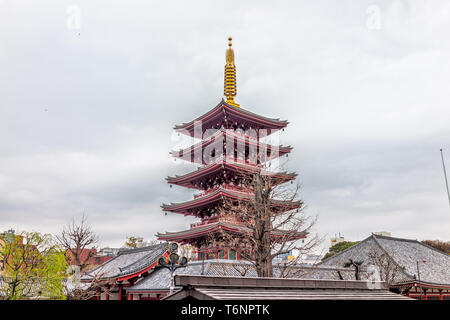 Tokyo, Japan Asakusa district area with roof view of Sensoji temple shrine with red architecture on cloudy day with pagoda Stock Photo