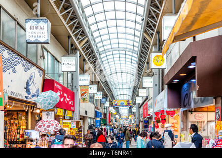 Tokyo, Japan - March 30, 2019: Asakusa area with crowd of people on Nakamise Shopping Street Arcade covered shops with roof Stock Photo