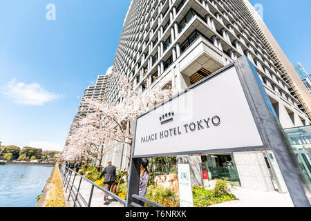 Tokyo, Japan - April 1, 2019: Sign for Palace Hotel in English wide angle closeup view of modern building by water in downtown Stock Photo