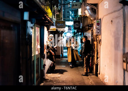 Shinjuku, Japan - April 3, 2019: Famous Golden Gai alley street in downtown city with night with people walking Stock Photo