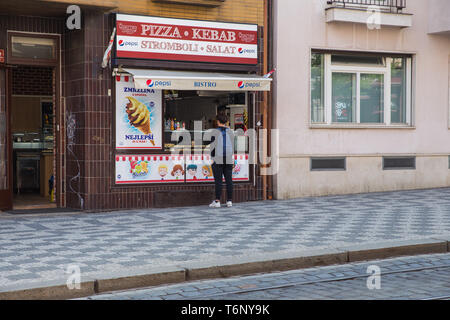 City Prague, Czech Republic.  On the street guy buys fast food. Fast food market. April 24. 2019 Travel photo. Stock Photo