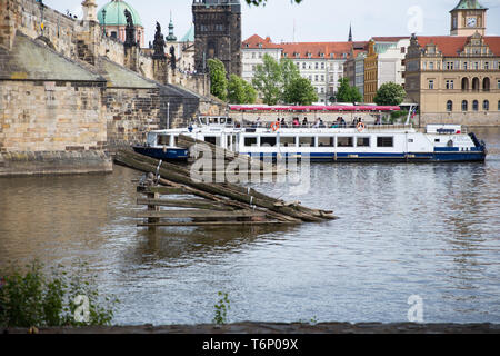 City Prague, Czech Republic. Tourists on the Charles bridge. Statues along the sides and boat in river Vltava. Travel photo 2019. 25. April Stock Photo