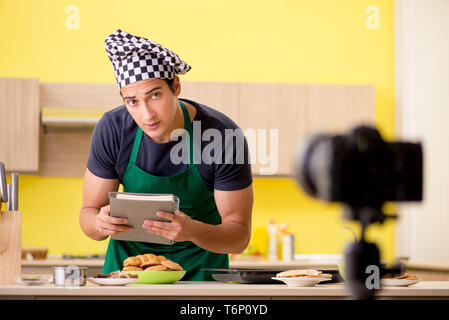 Young chef blogger explaining food preparation Stock Photo