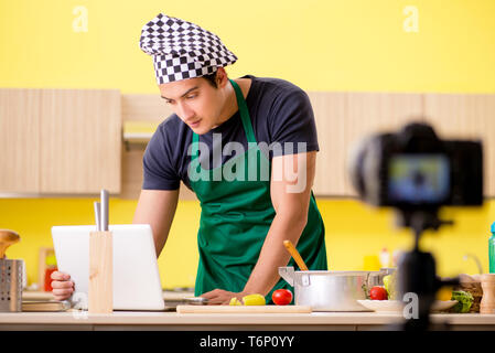 Young chef blogger explaining food preparation Stock Photo
