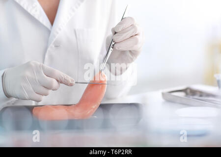 Scientist examining meat sample in laboratory Stock Photo