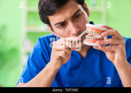 Man dentist working on new teeth implant Stock Photo