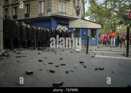 May 1, 2019 - Thousands gathered for May Day protests in the French capital with clashes breaking out between some of the protesters and the police. Many yellow vest protesters joined the rally as well as some Black Bloc anti-capitalist groups. Several hundreds of police officers had been deployed in Paris, and they fired tear gas and used baton charges to push back demonstrators. Thousands of people joined this year May Day rally in France to fight for workers' rights and to protest against President Emmanuel Macron's economic policies. According to the French labour union CGT, all march Stock Photo