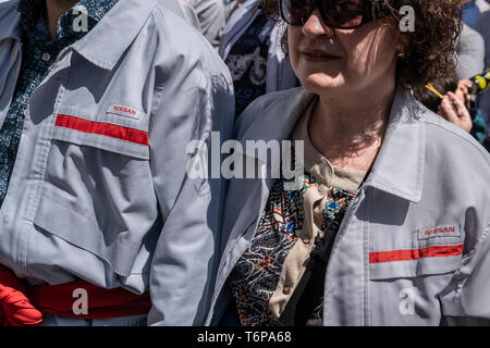 Two workers of the car manufacturer Nissan that currently suffers high staff cuts is seen during the International Worker's Day demonstration. The two major Spanish trade unions CC.OO and UGT, accompanied by a large number of parties and social organizations have celebrated the May Day, International Workers Day with a demonstration in the streets of Barcelona under the slogan 'First people.' Stock Photo