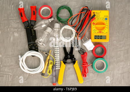 Flat lay composition with electrical tools on grey background Stock Photo