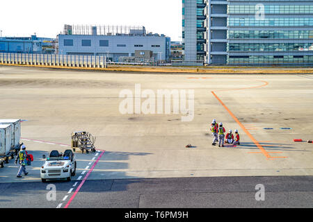 Kansai region, Osaka, Japan - 4 Mar 2018: Local specialist air plane staff is working and meeting on the field in the afternoon at Kansai Internationa Stock Photo