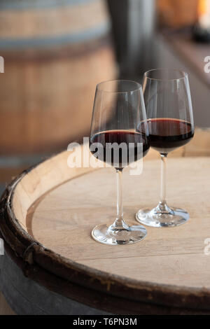 Two glasses of red wine on a cask *** Local Caption *** Stock Photo